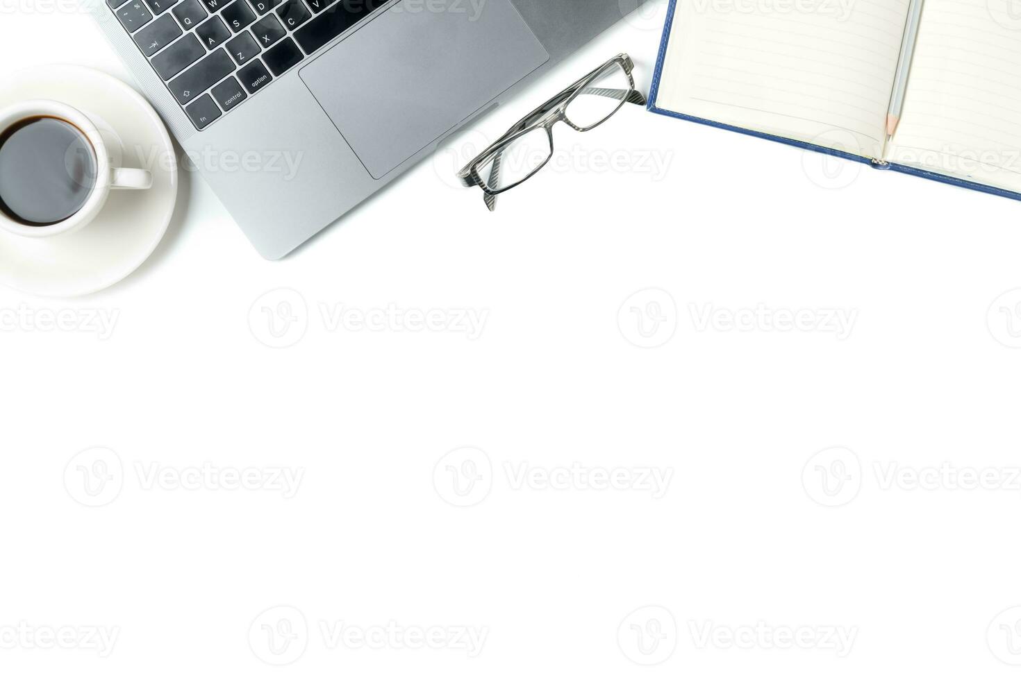 Desk with laptop, eye glasses, notebook and a cup of coffee isolated photo