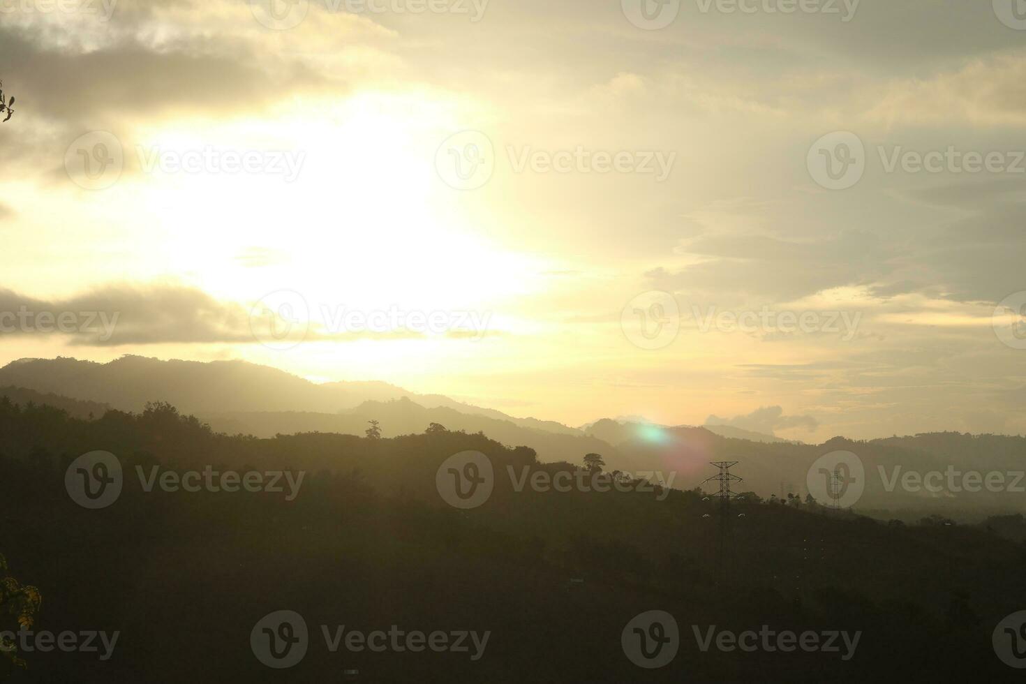 The sun rises over the mountains photo