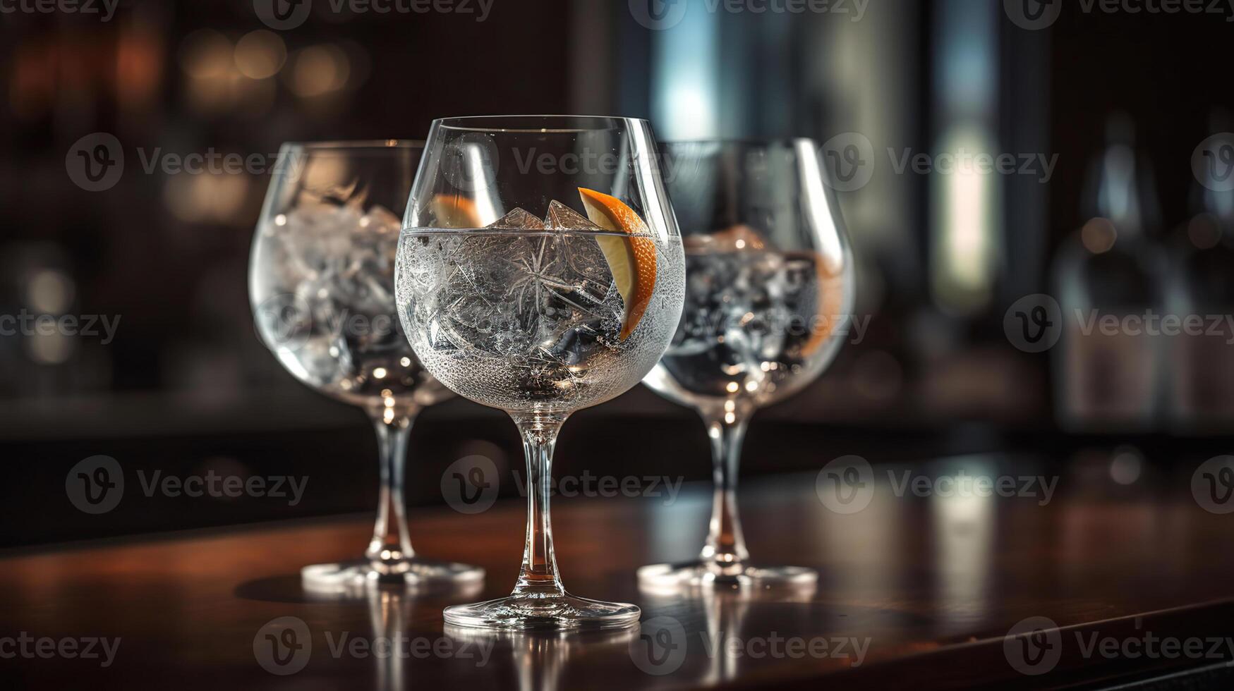 Glasses of cold gin tonic on table in bar with black baground, photo