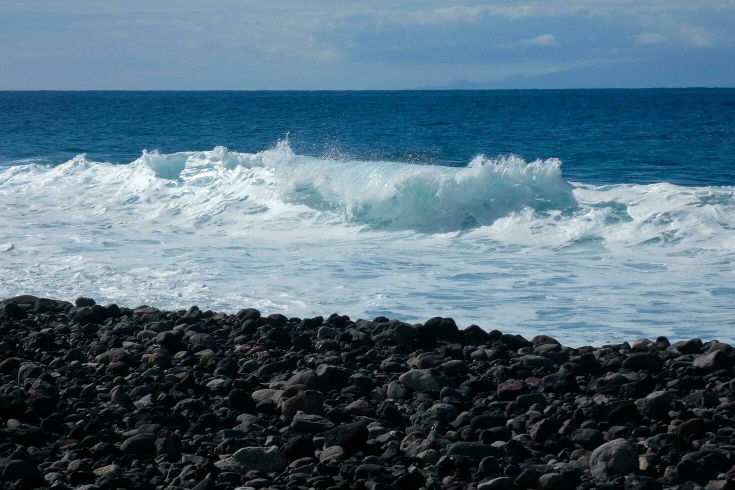 Large waves crashing against the rocks in the ocean photo