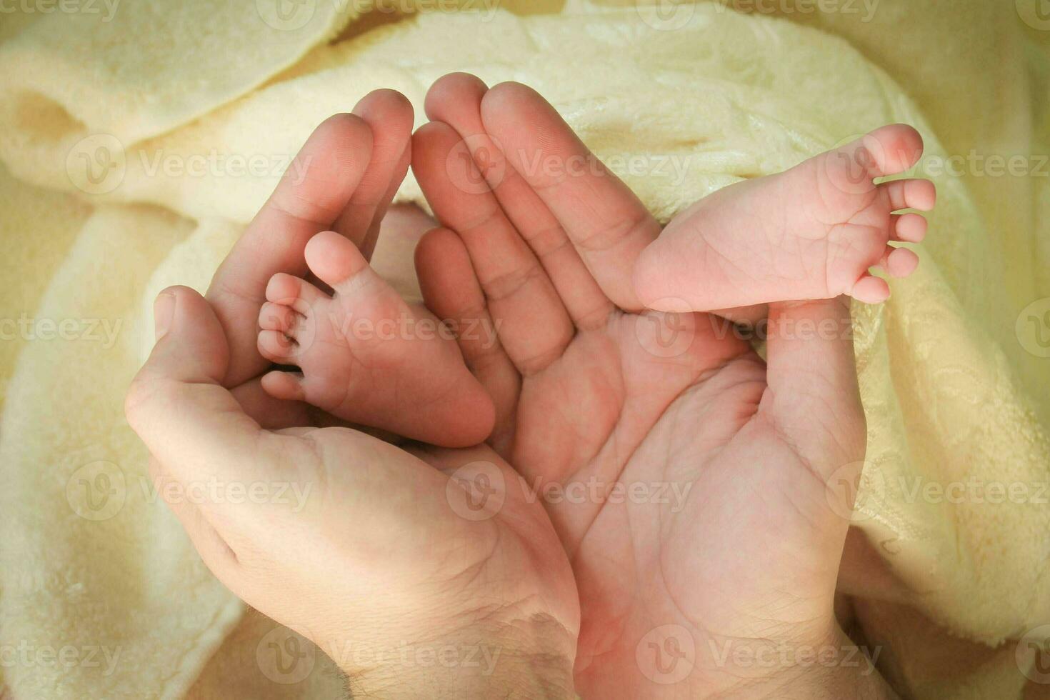 Baby legs in daddy's hands photo