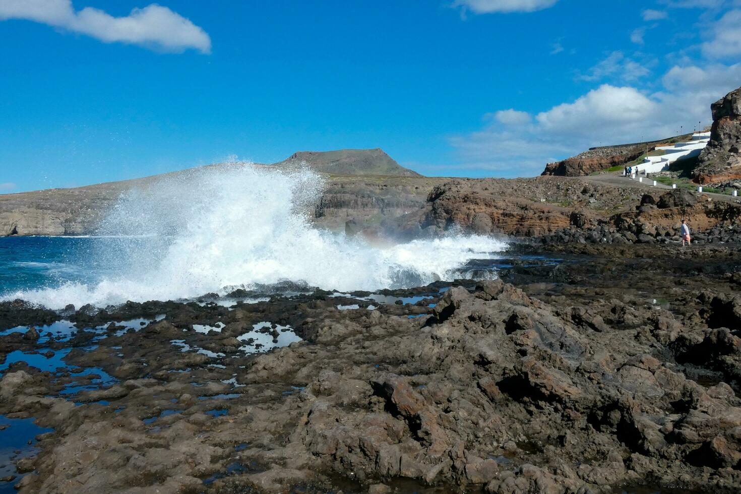 Large waves crashing against the rocks in the ocean photo