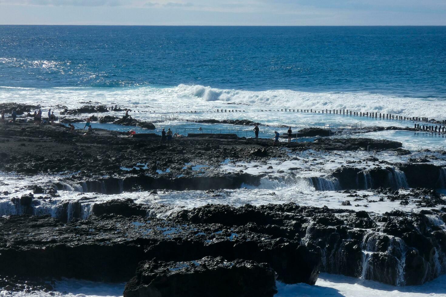 Large waves crashing against the rocks in the ocean photo