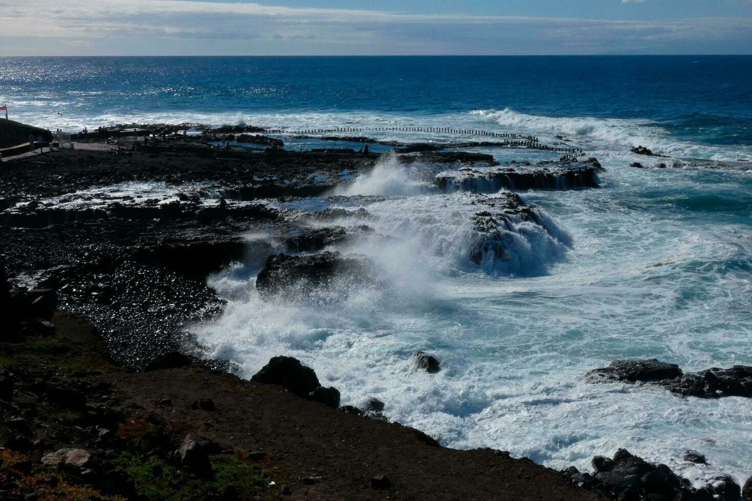 Large waves crashing against the rocks in the ocean photo