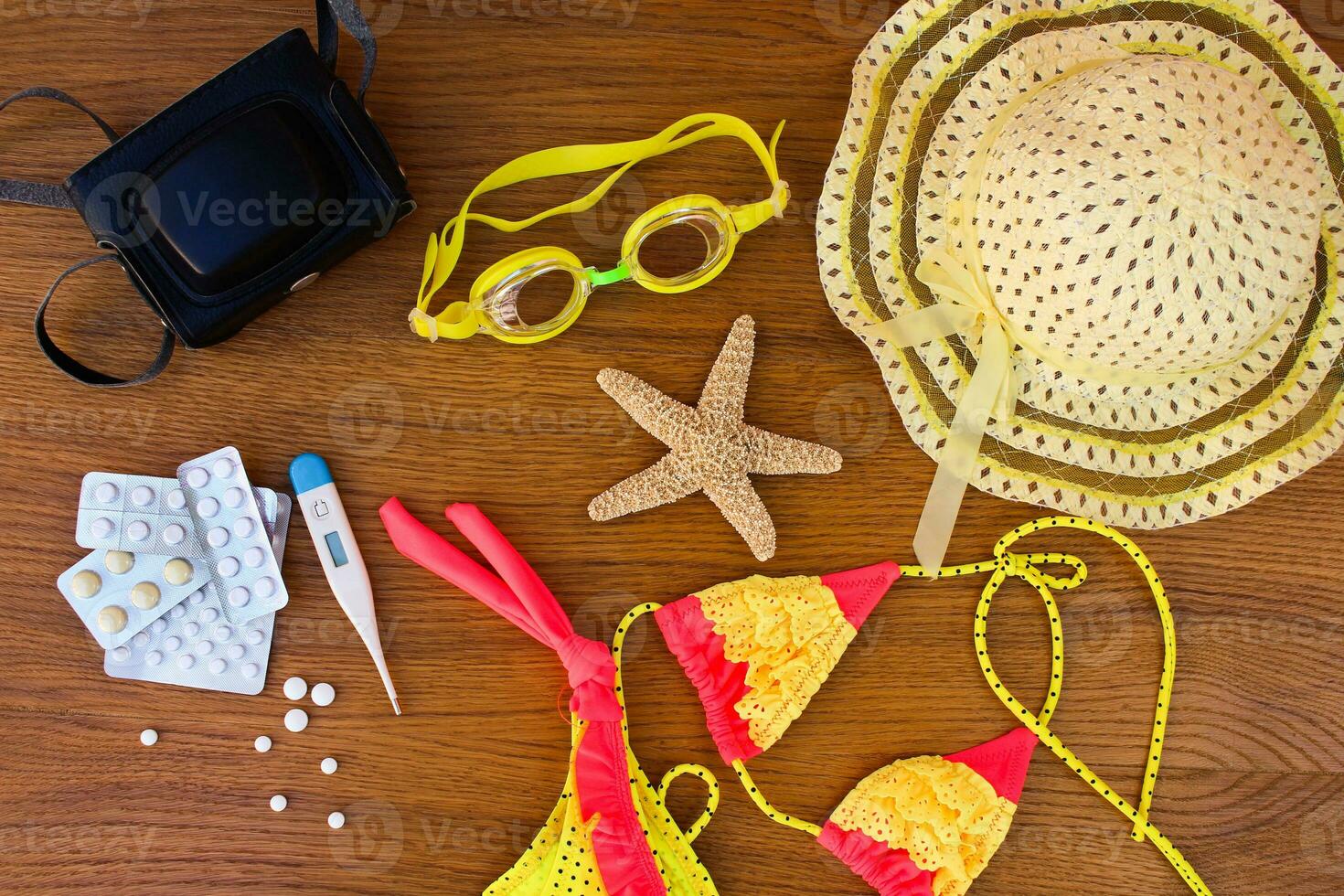 Summer beach accessories and medicine on the table. The concept of medication required in the journey photo