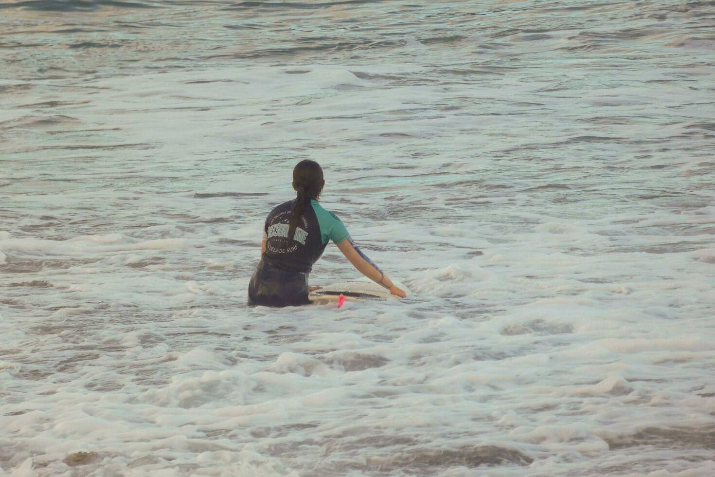 Surfers riding small ocean waves photo