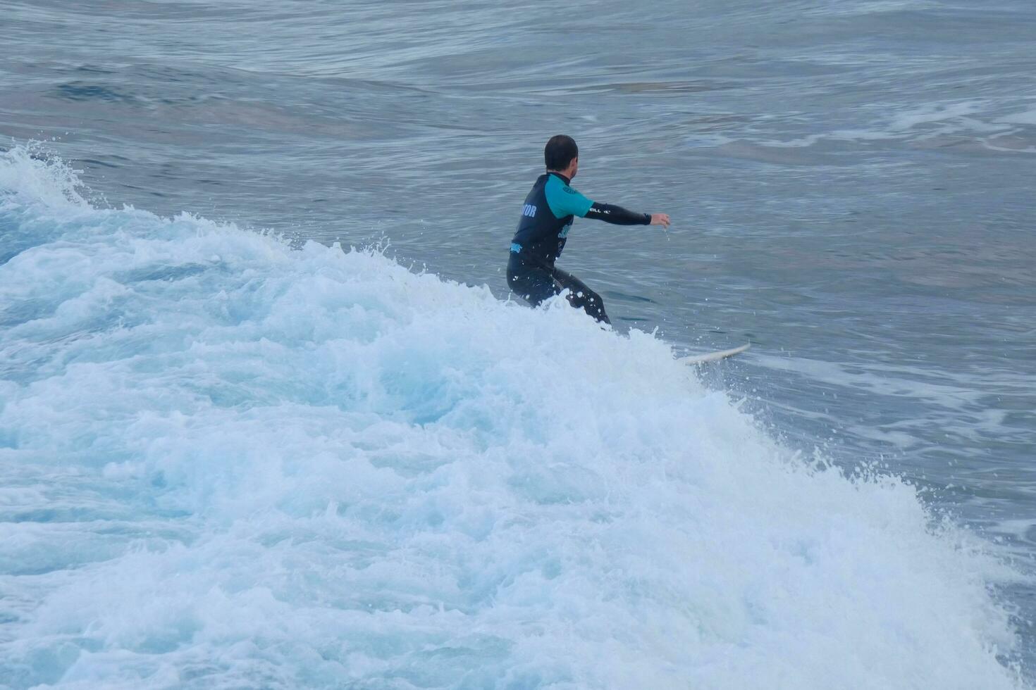 Surfers riding small ocean waves photo