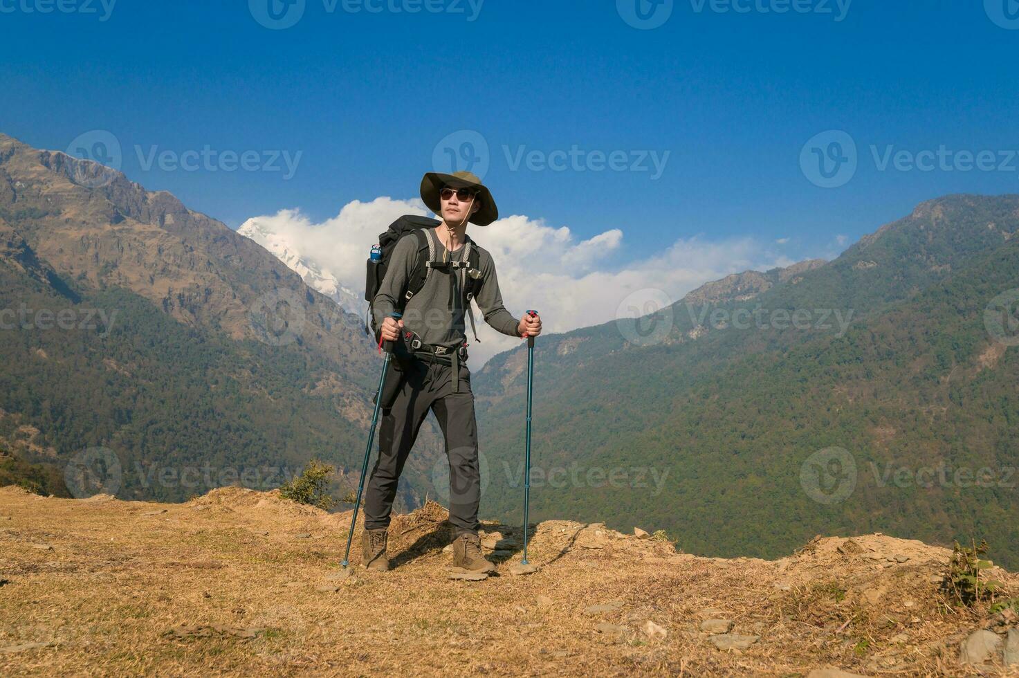 A young traveller trekking on forest trail , Nepal photo