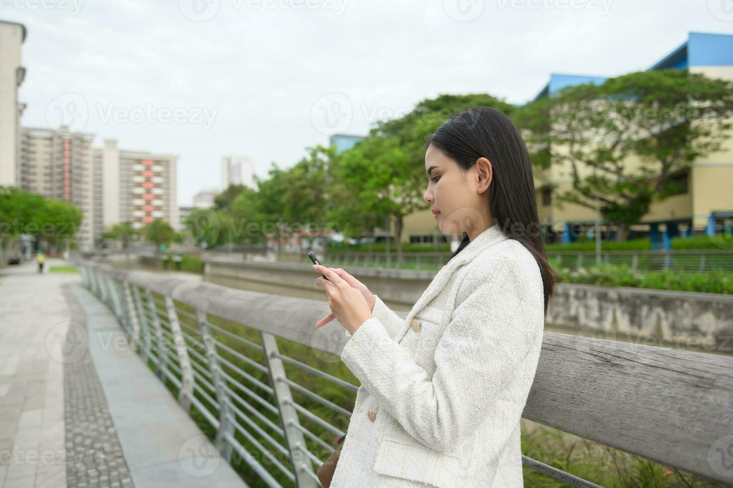 A young businesswoman is working in modern city downtown of Singapore photo