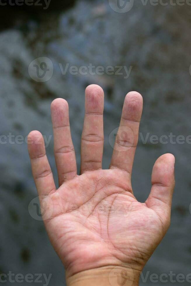 Wrinkled hand in a pool photo