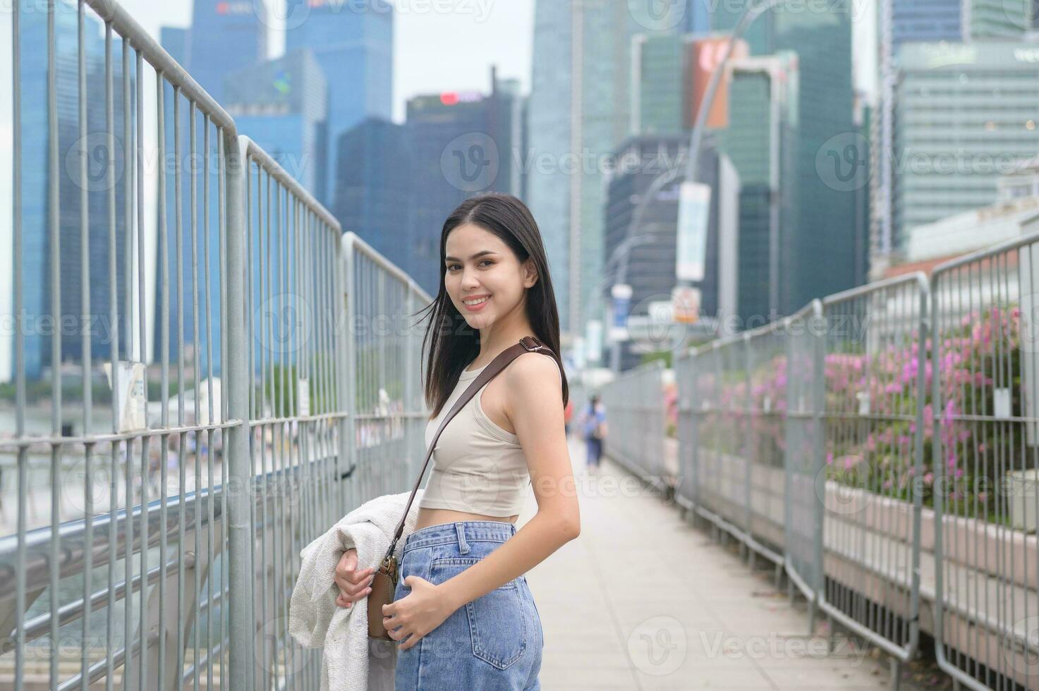 A young businesswoman is working in modern city downtown of Singapore photo