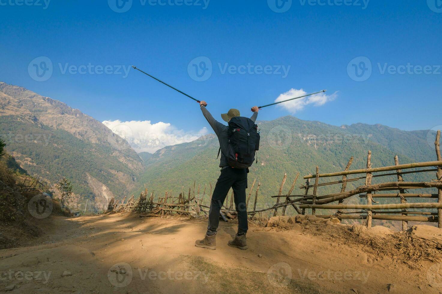 A young traveller trekking on forest trail , Nepal photo