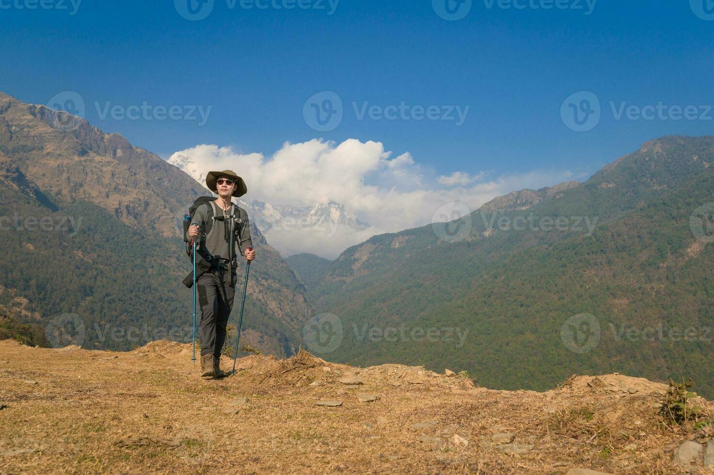 A young traveller trekking on forest trail , Nepal photo