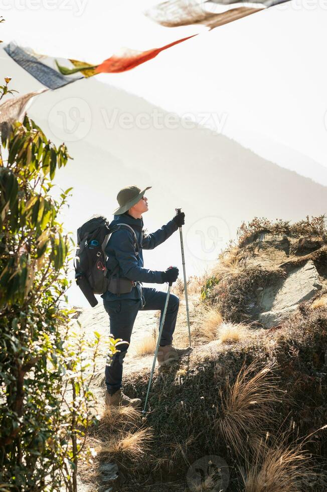 A young traveller trekking on forest trail , Nepal photo