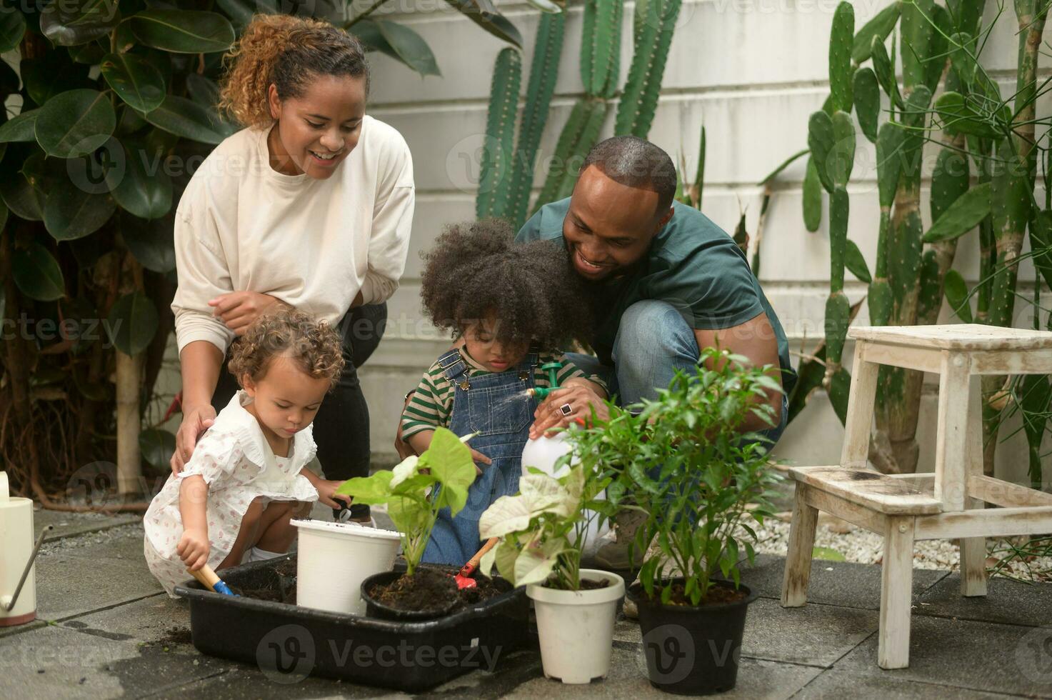 Happy African American family enjoying gardening at home photo