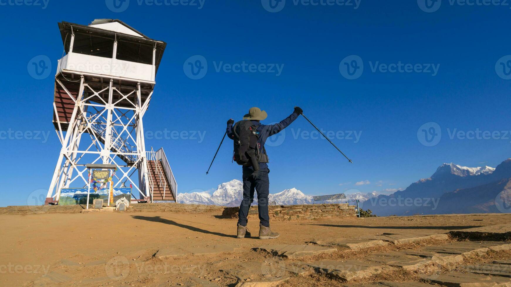 A young traveller trekking in Poon Hill view point in Ghorepani, Nepal photo