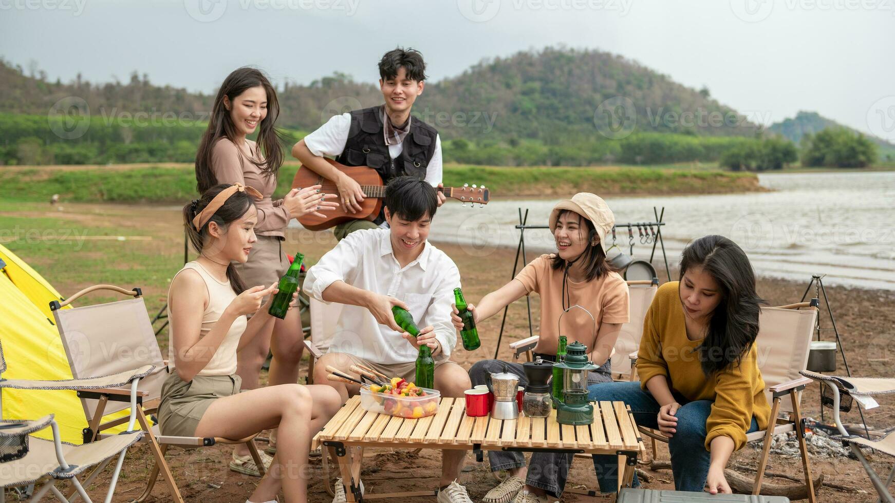 Group of young  Asian people are enjoy camping in natural campsite photo