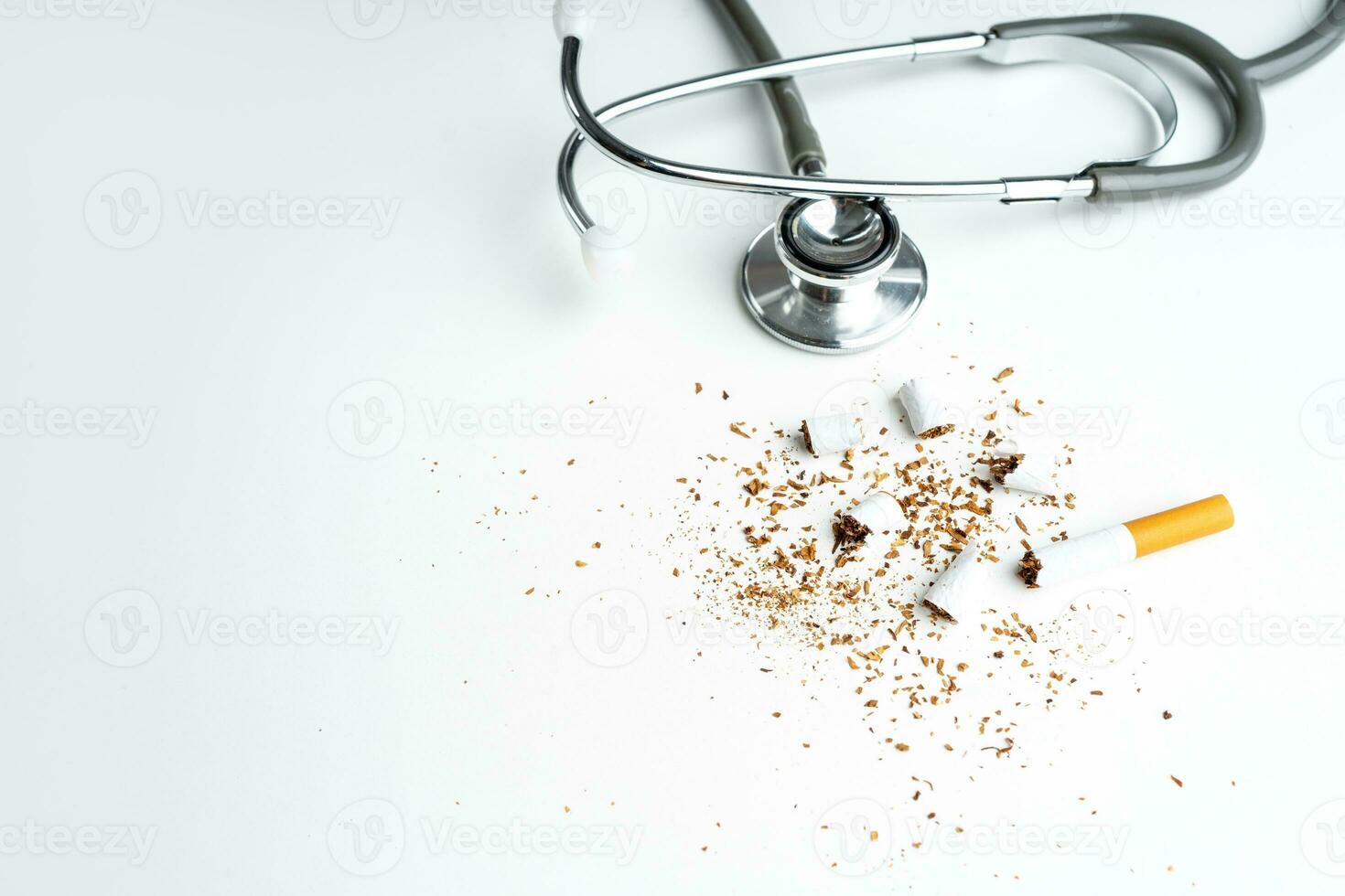 Cigarette with stethoscope on white background with copy space. The drug is harmful to the respiratory system. photo