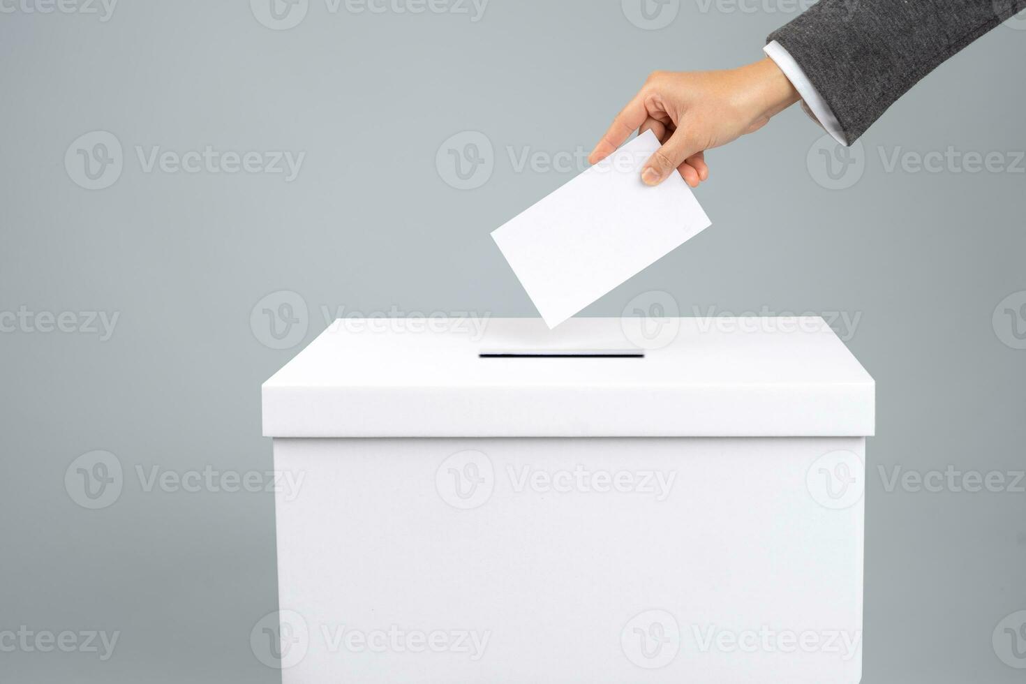 Man putting his vote into ballot box, closeup. The concept of free democratic vote elections. photo