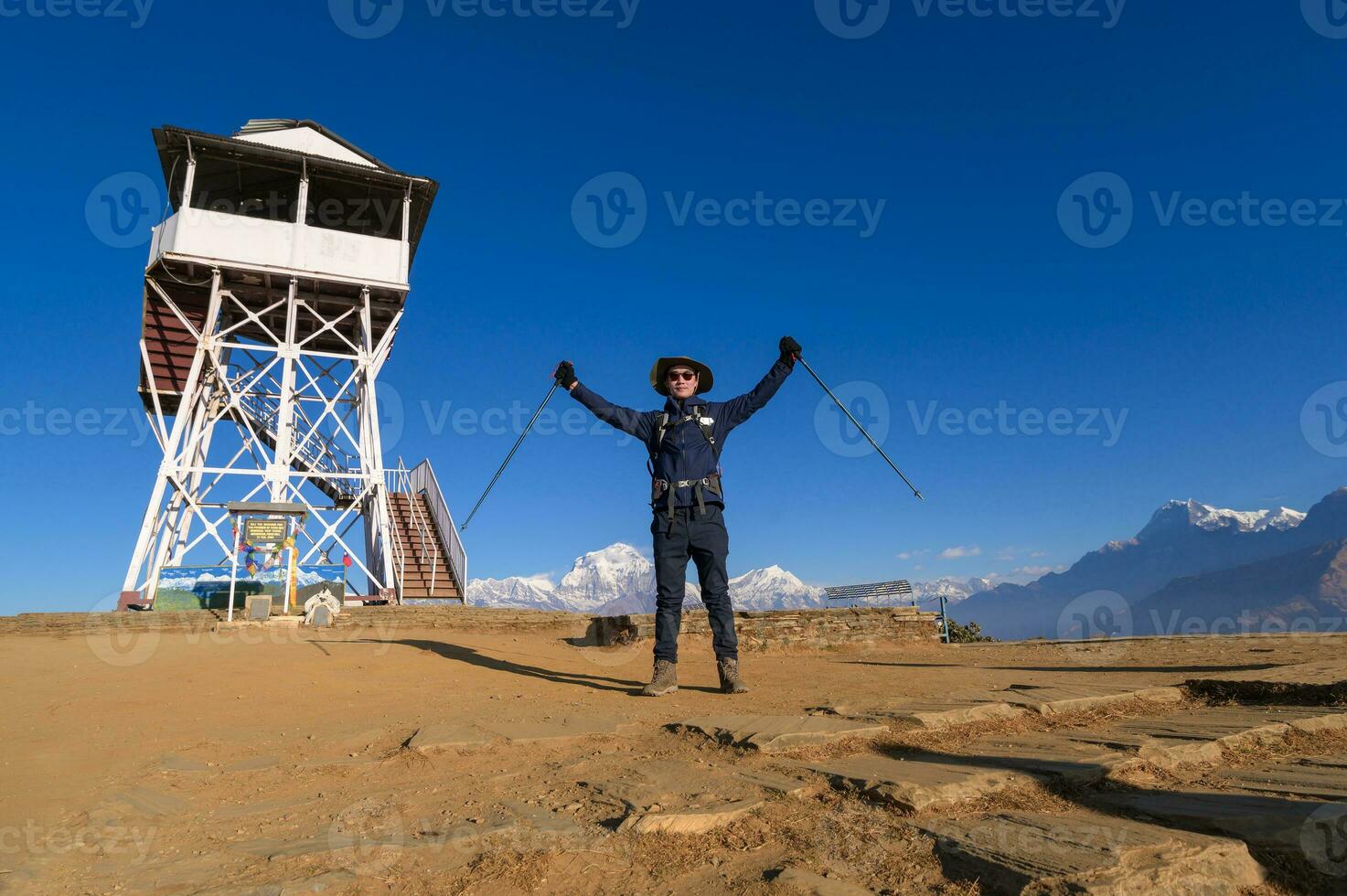 A young traveller trekking in Poon Hill view point in Ghorepani, Nepal photo