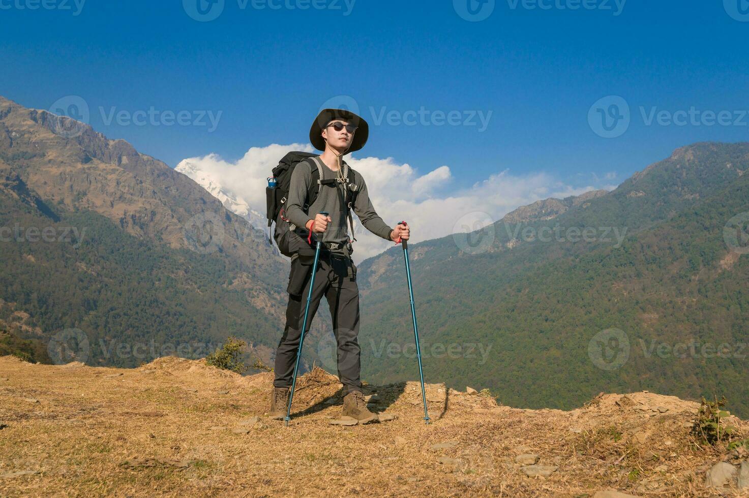 A young traveller trekking on forest trail , Nepal photo