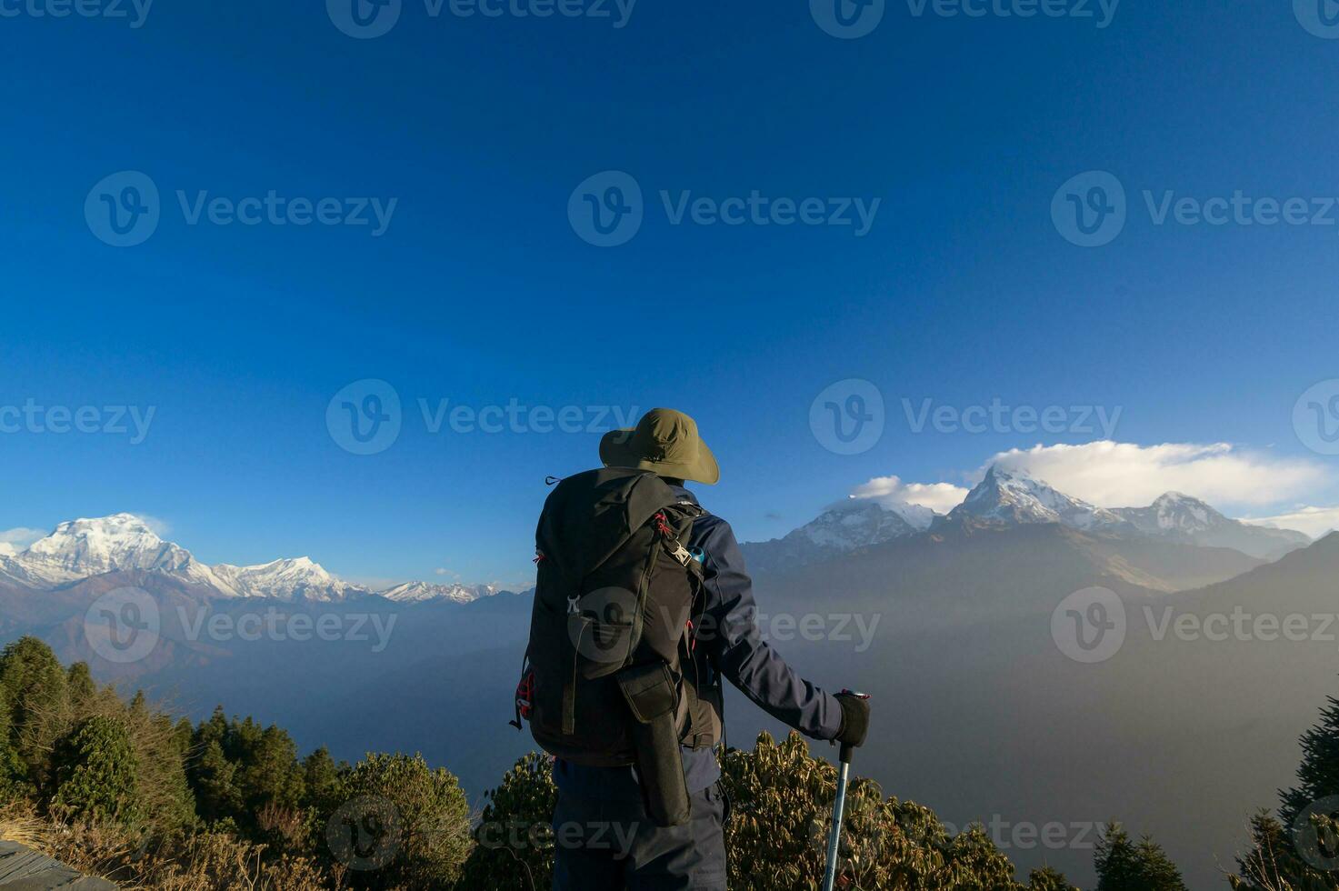 A young traveller trekking in Poon Hill view point in Ghorepani, Nepal photo