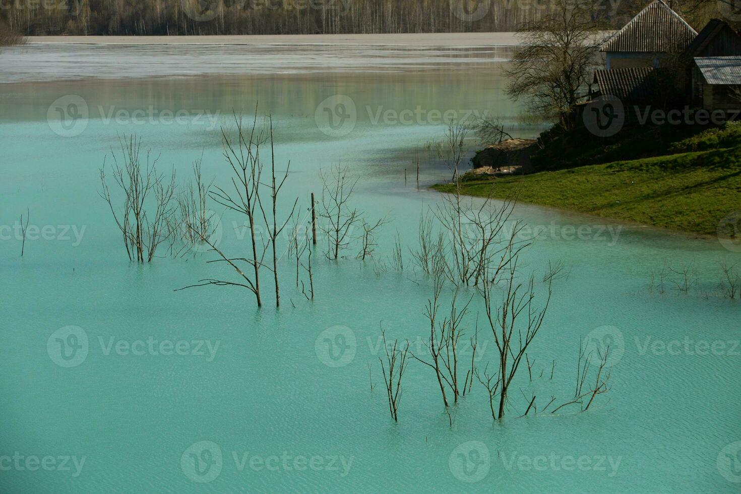 A lake contaminated with toxic waste in the western mountains of Romania. Nature pollution from copper mine. Ecological catastrophe or Environmental disaster photo