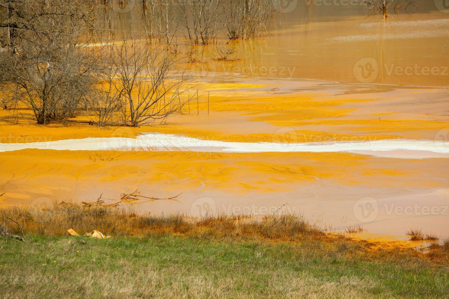 A lake contaminated with toxic waste in the western mountains of Romania. Nature pollution from copper mine. Ecological catastrophe or Environmental disaster photo