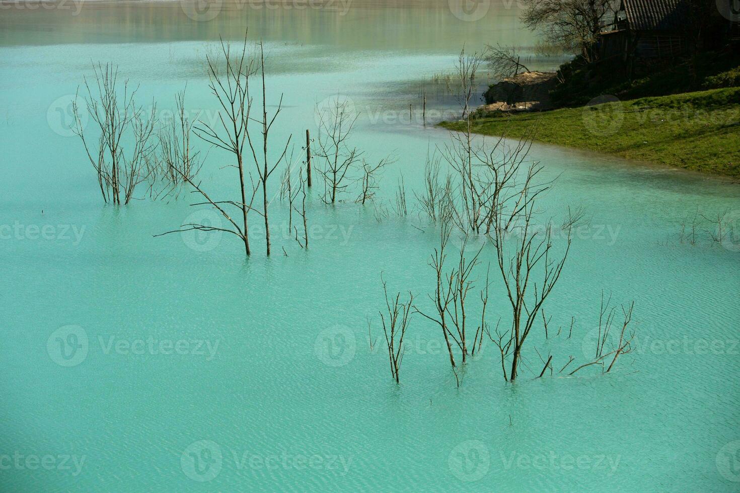 A lake contaminated with toxic waste in the western mountains of Romania. Nature pollution from copper mine. Ecological catastrophe or Environmental disaster photo