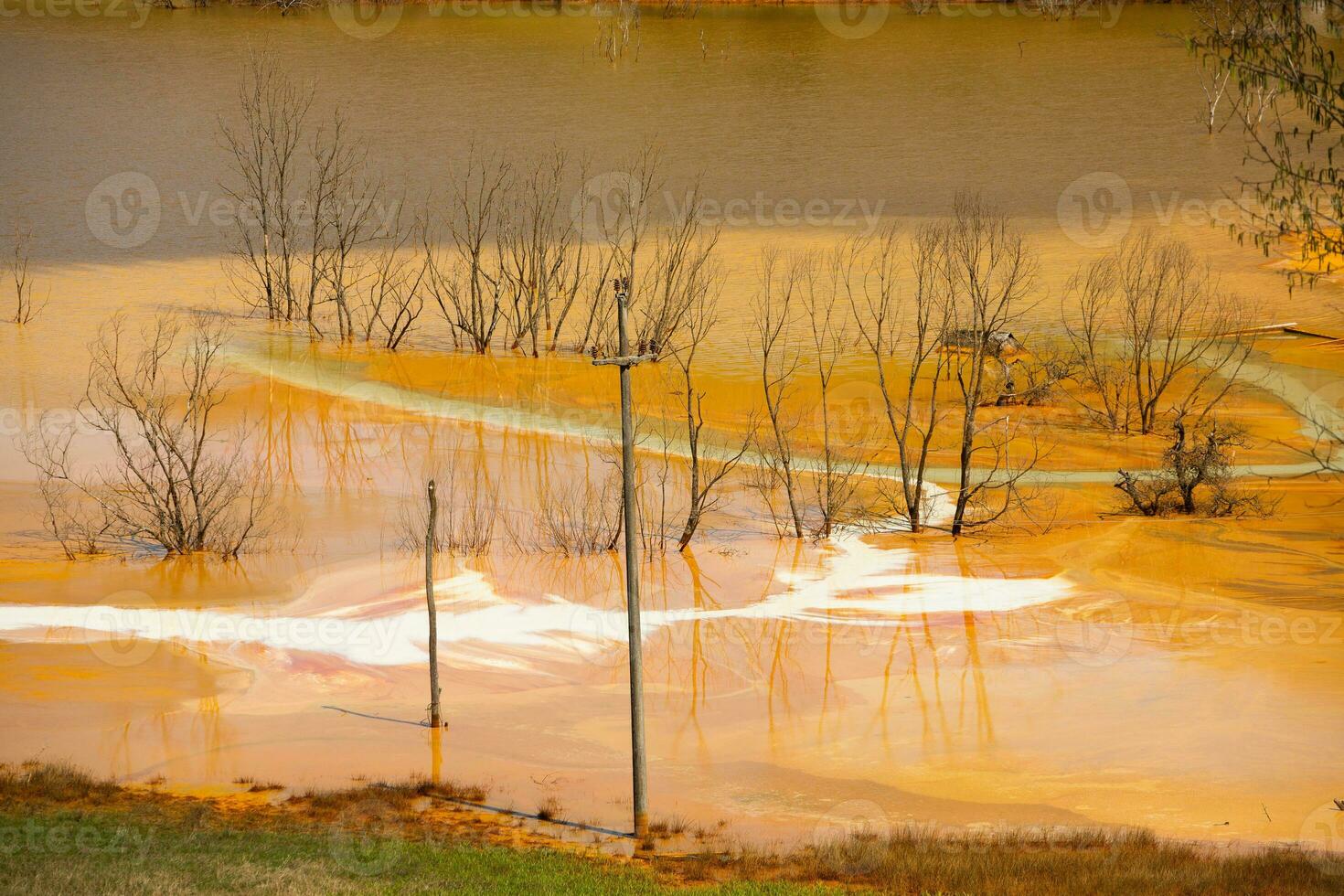 A lake contaminated with toxic waste in the western mountains of Romania. Nature pollution from copper mine. Ecological catastrophe or Environmental disaster photo