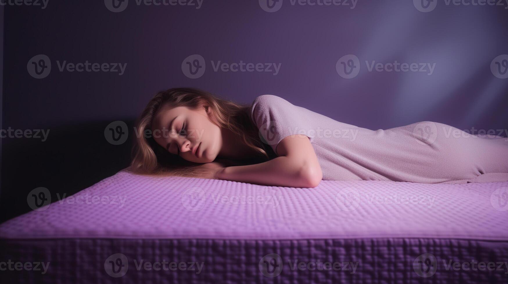 Young woman sleeping on soft mattress against light purple background, photo