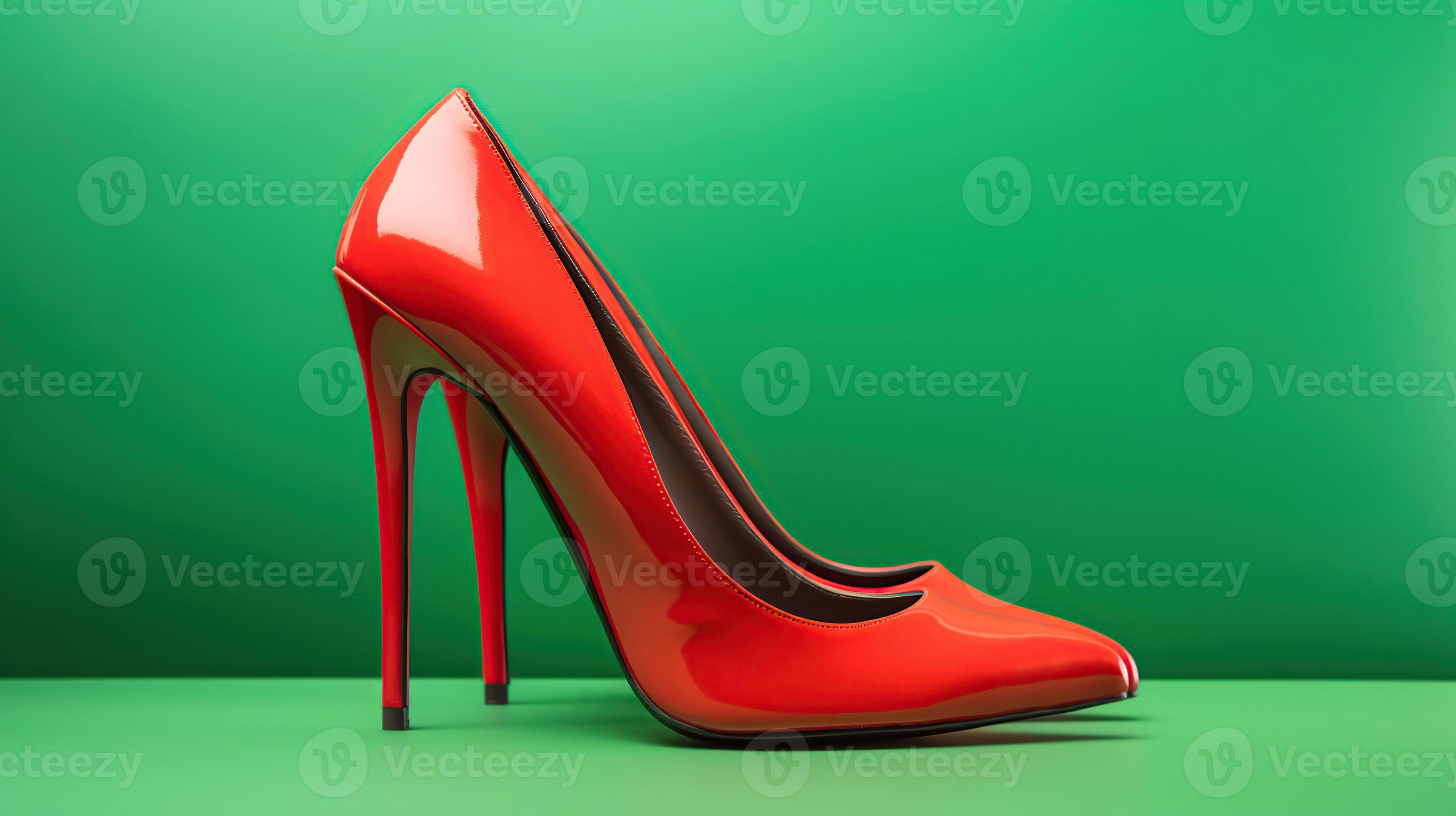Red high heels isolated on a bright green pastel background. A modern