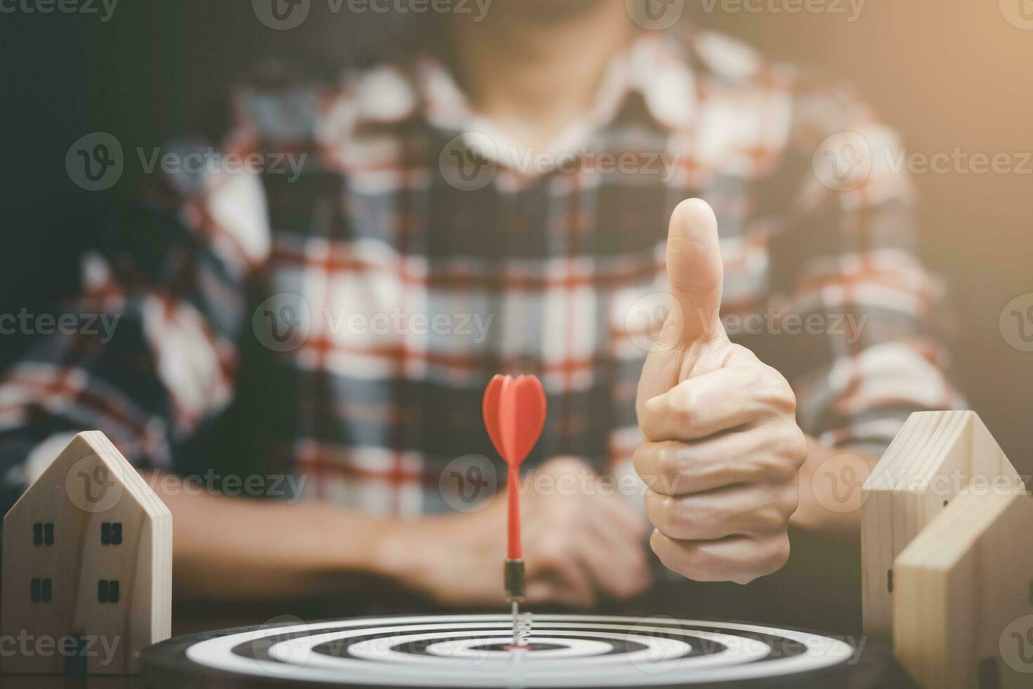 Businessman showing thumbs up mini and wood house model from the model on wood table, Planning buy Real Estate, Planning to buy the property. concept of Choose the best. photo