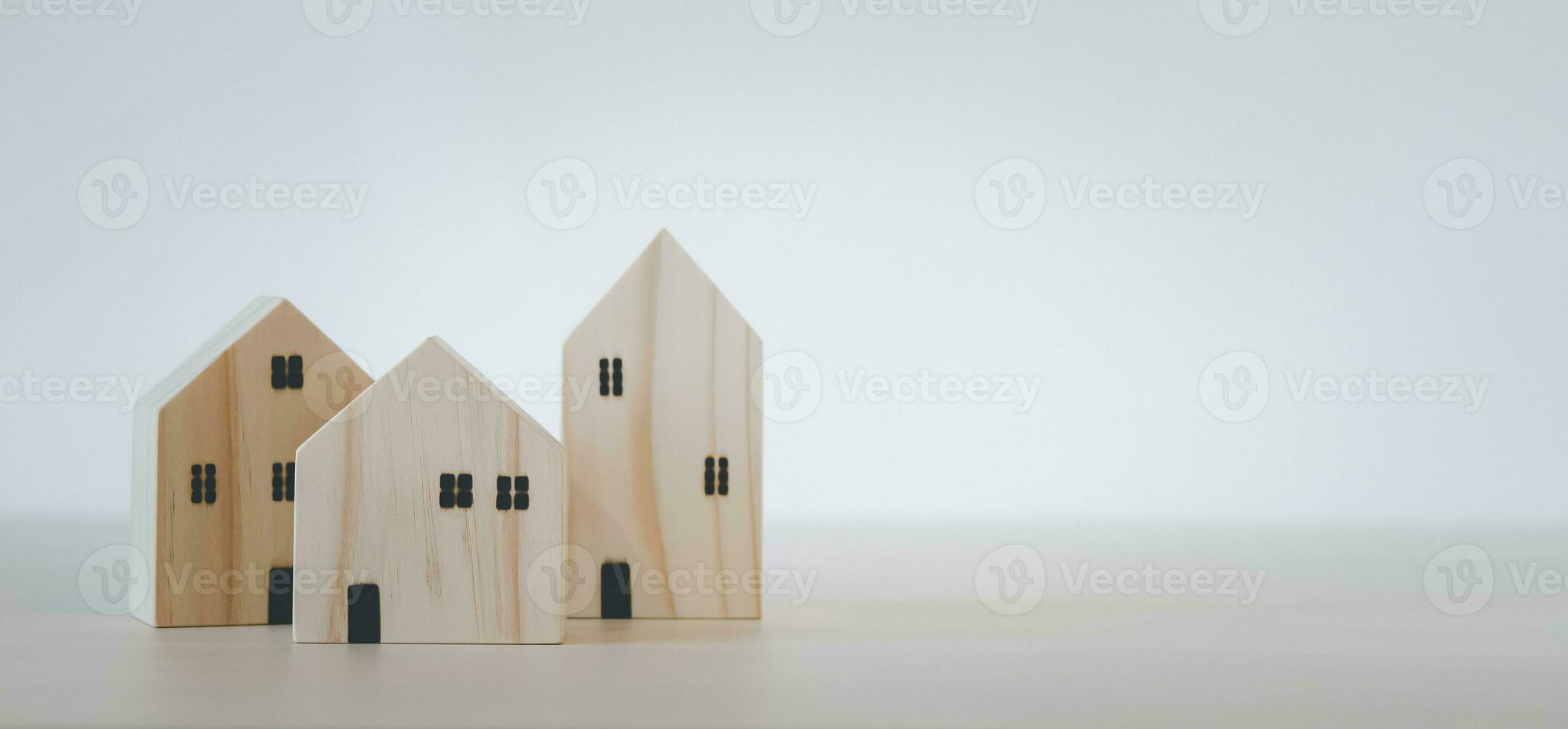 Mini wood house model from model on wood table, Planning buy Real Estate, Planning to buy property and Choose the best. work from home and stay at home concept. photo