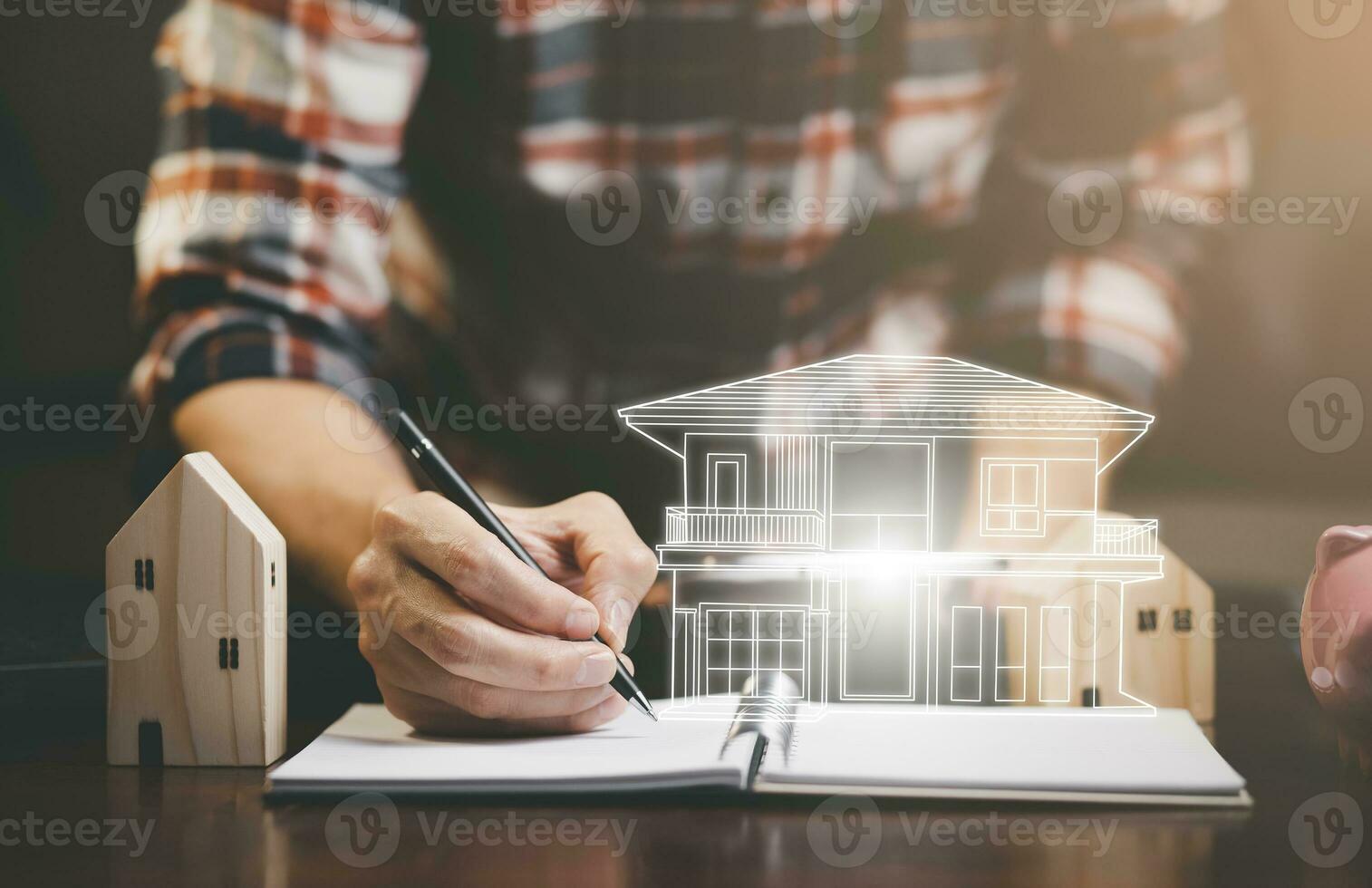 Engineering and architecture drawings and mini home model concept, Engineer man writing of architect starting draw a house blueprint on the desk in the home office, work from home, Real estate offer photo