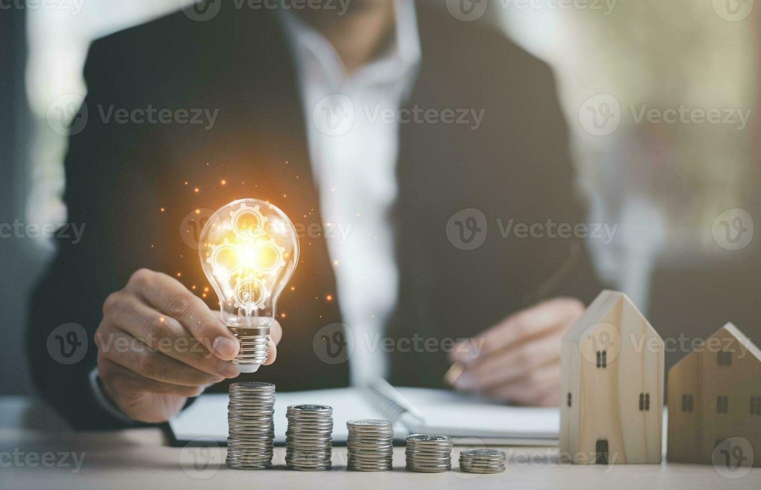 Businessman hand holding light bulb with line connect and Coins stack on the wooden table, Saving ideas and investment budget, Creative ideas concept of saving money  concept, Copy space photo