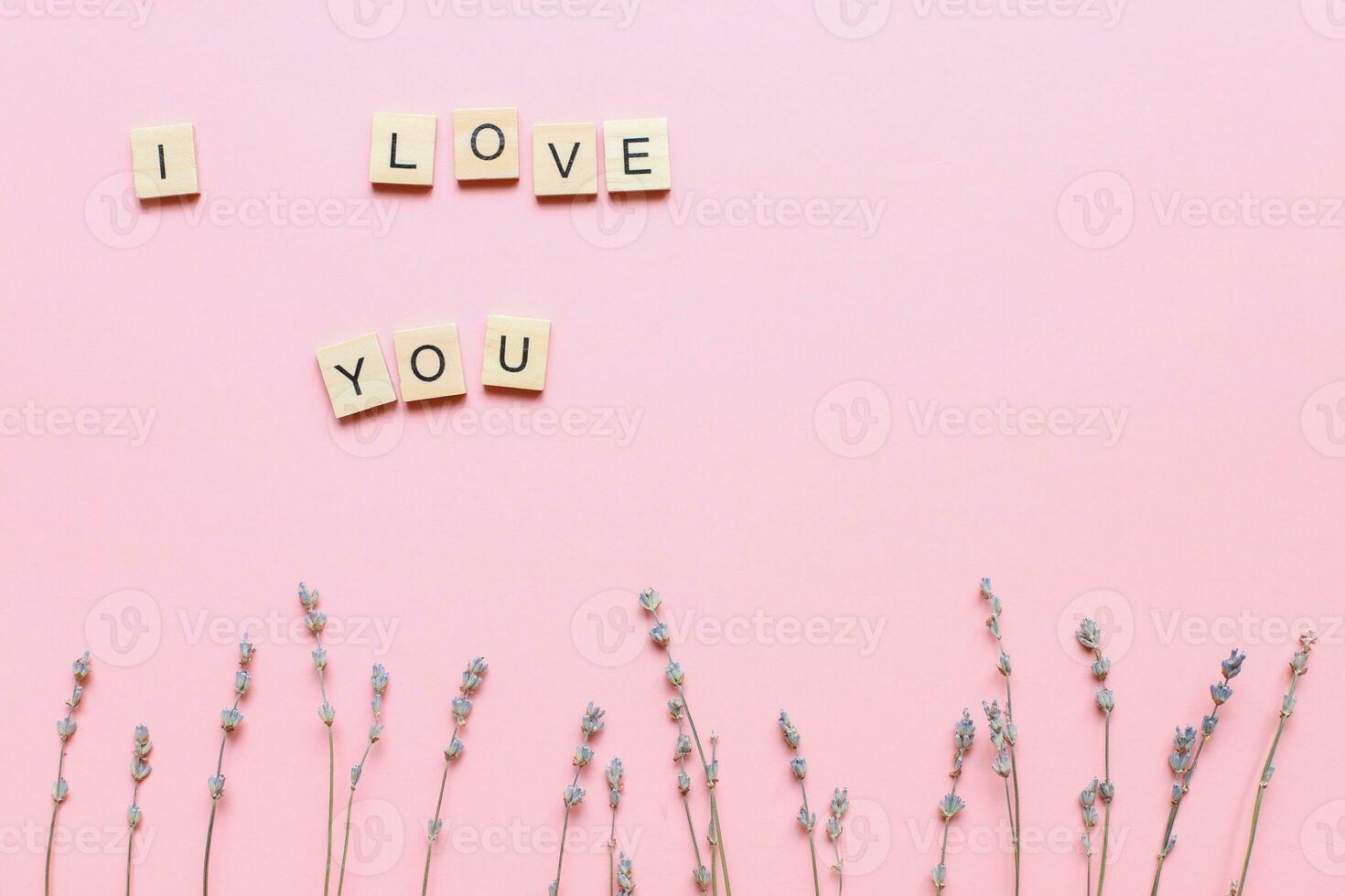 I love you made of wooden letters on a pink background with flowers. mothers day card. Flat lay for mothers day photo