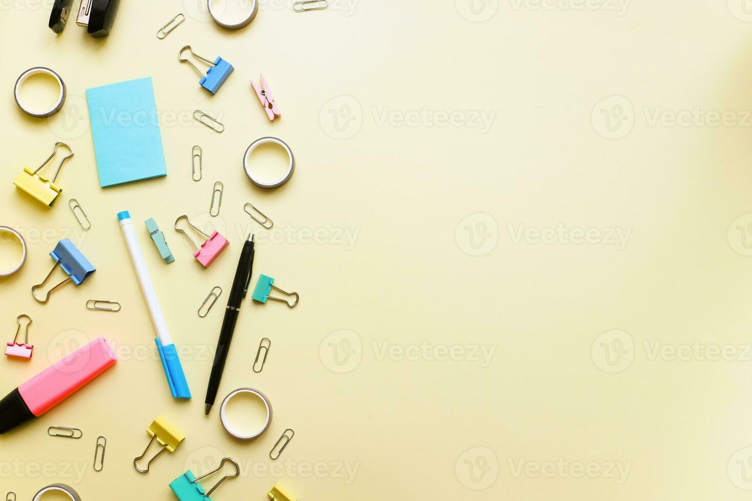 Flat lay office supplies on yellow background photo