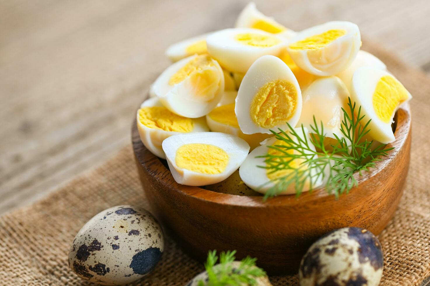 boiled eggs food, quail eggs on wooden bowl, breakfast eggs with fresh quail eggs and vegetable lettuce on table background photo