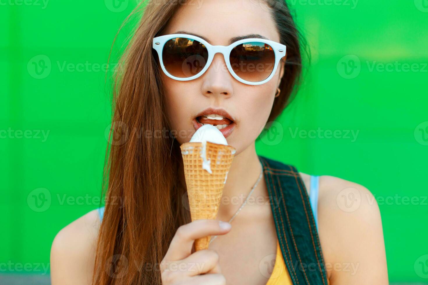 Pretty young woman eating ice cream. photo