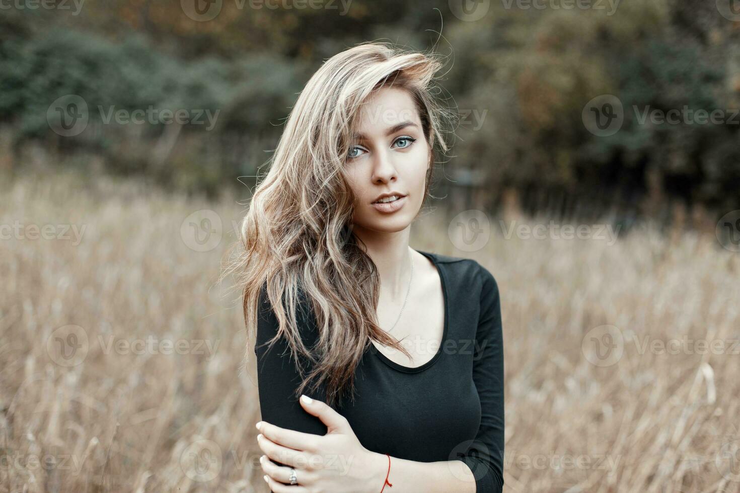 Beautiful girl model in black t-shirt posing in the corn field photo
