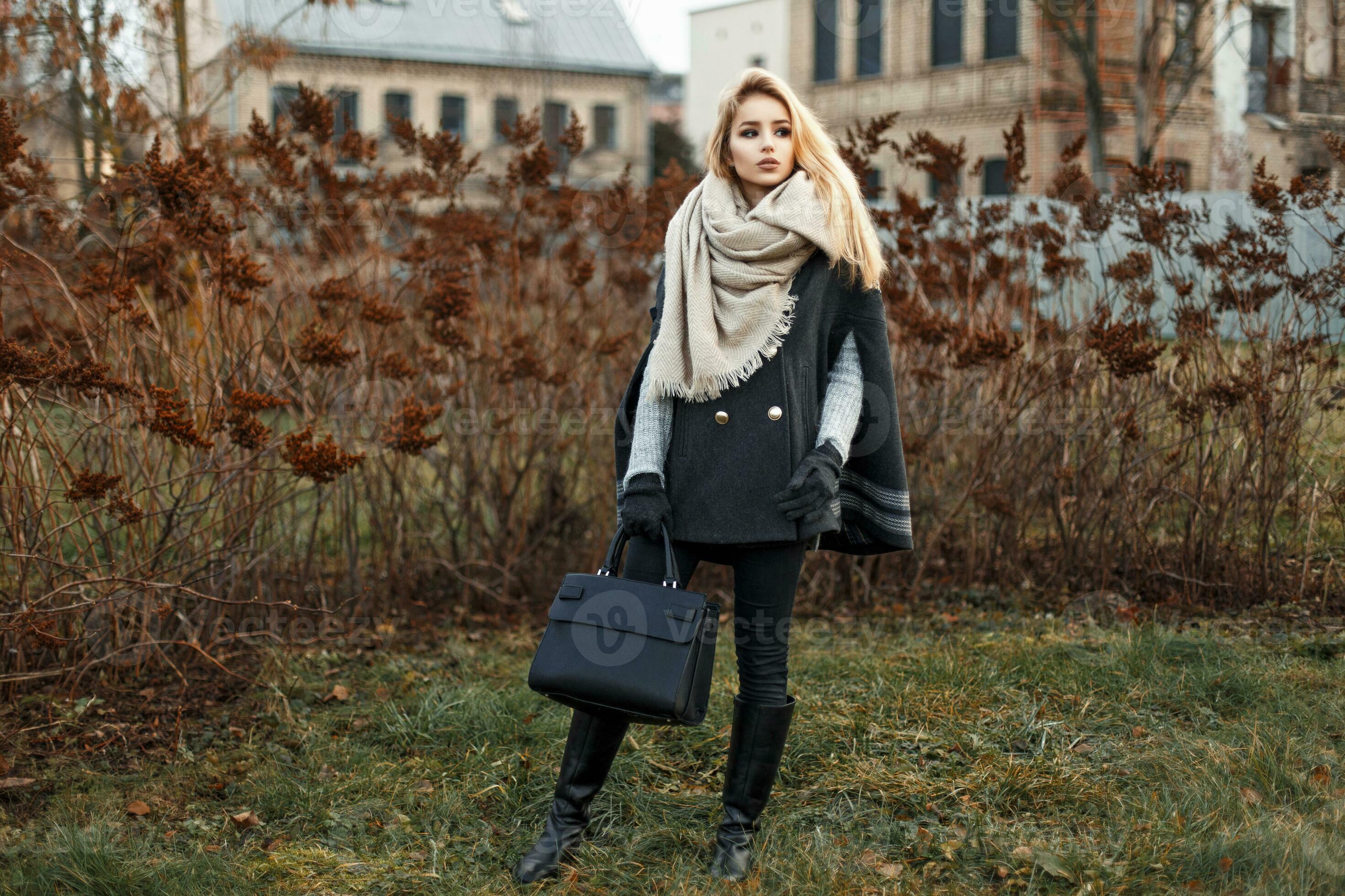 Premium Photo  Stylish beautiful young woman in fashionable elegant clothes  with a coat, hat and leather handbag walks in the city. glamorous feminine  style and beauty