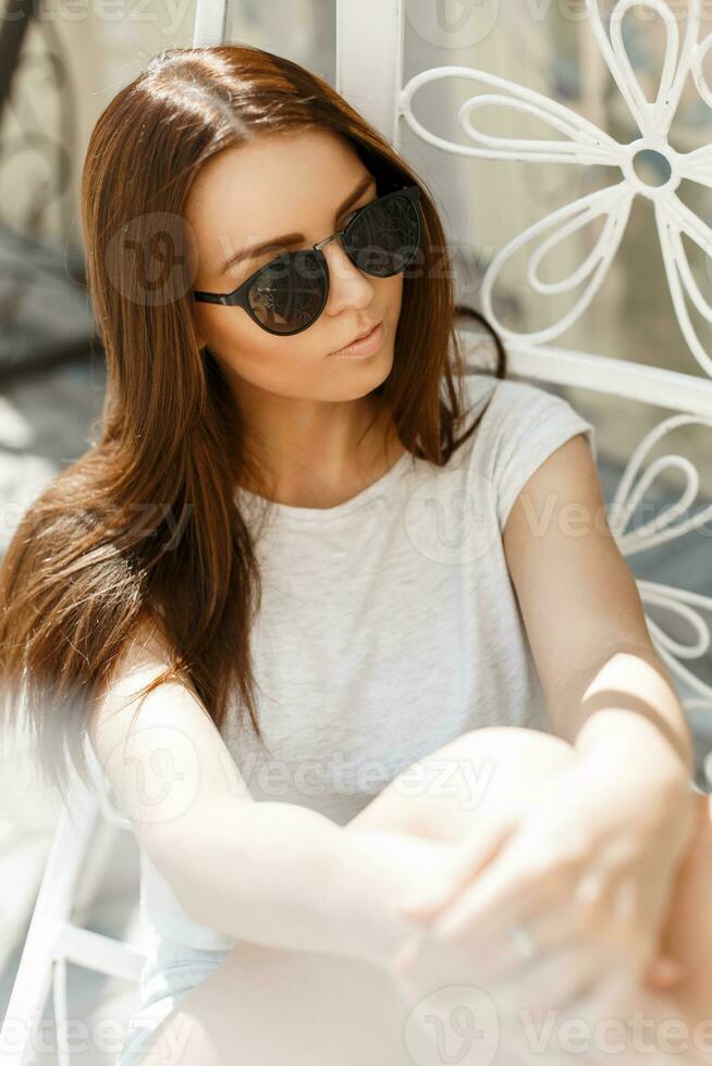 Beautiful girl in sunglasses on a summer sunny day rest photo