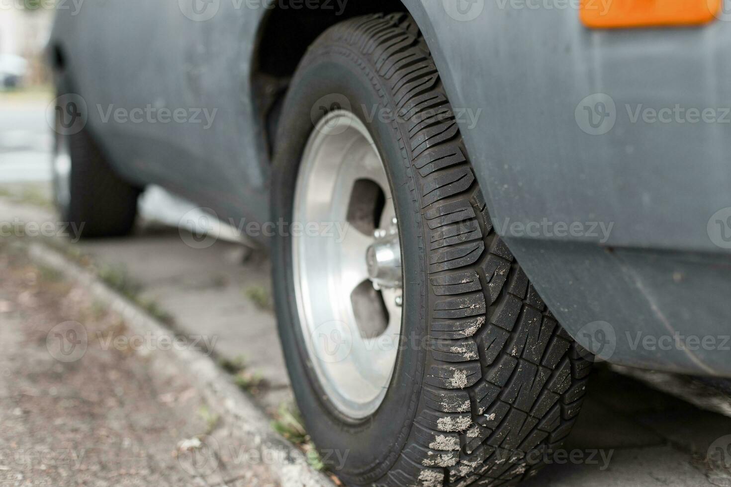 Car tire on old vintage automobile photo