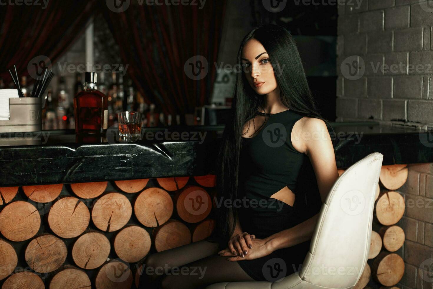 Beautiful young woman relaxing in a bar. photo
