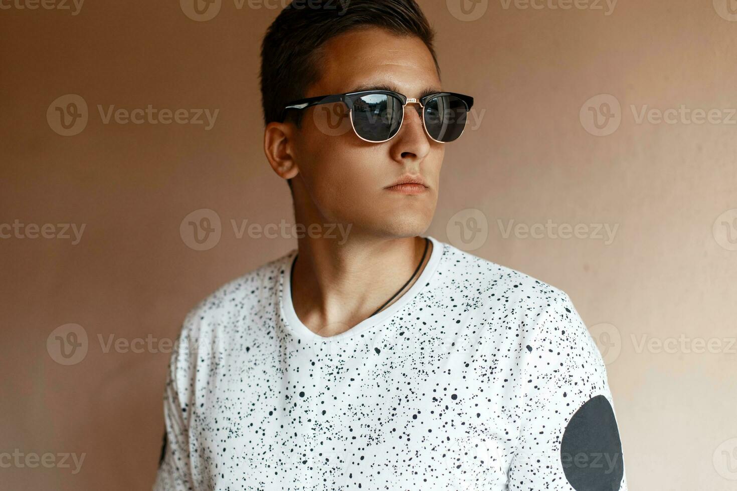 Portrait of a young handsome man in sunglasses. photo
