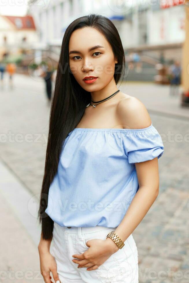 Beautiful Asian woman walking in the city photo