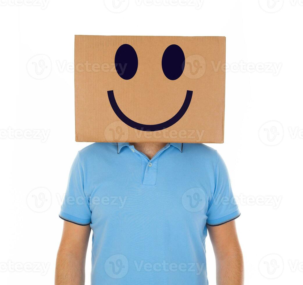 Man standing with a cardboard box on his head with smiley face photo