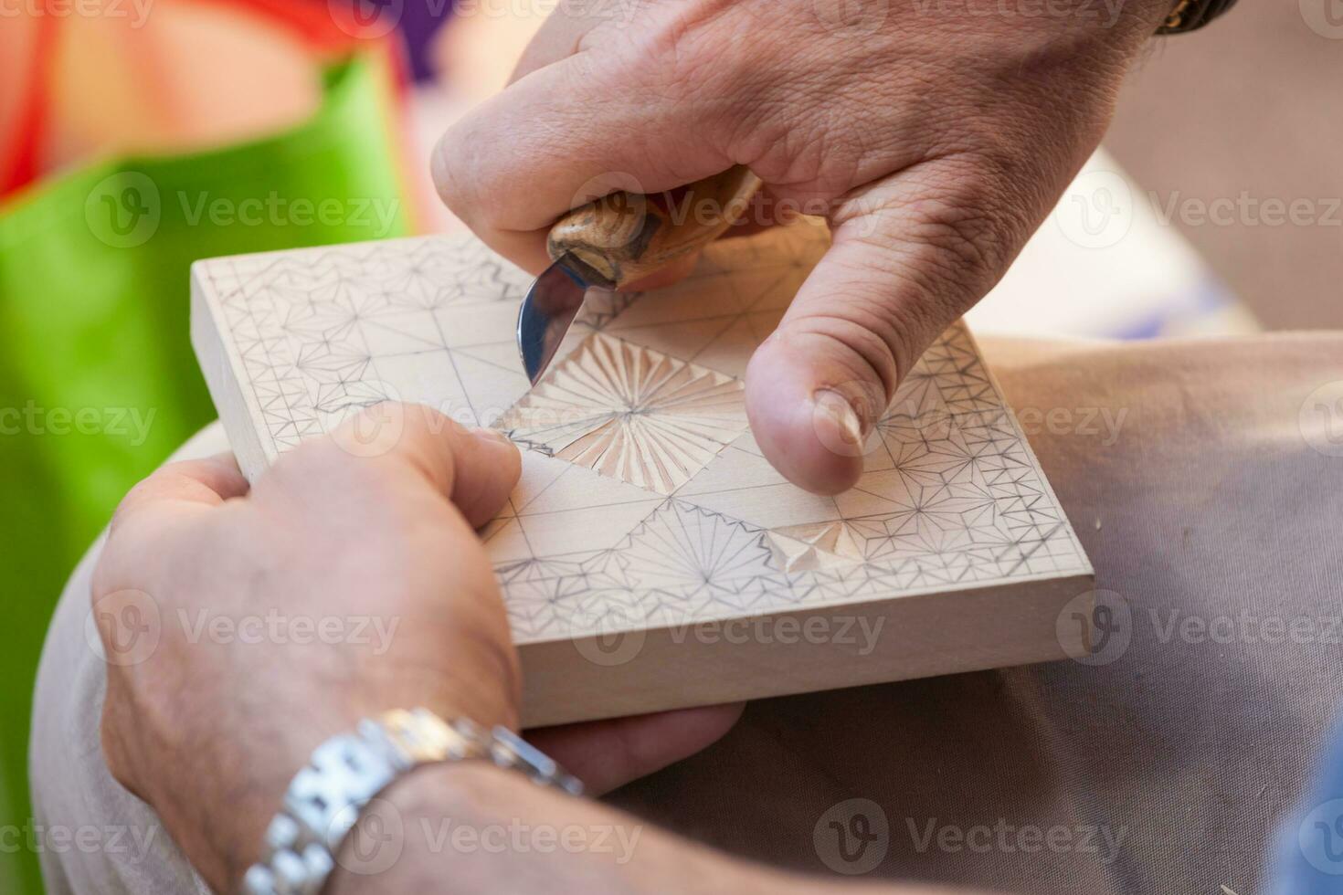 Hands of craftsman while carving the wood photo