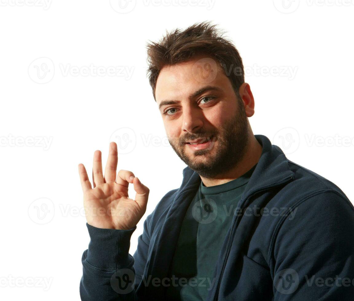 Smiling young man gesturing ok sign photo